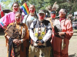 Sharp, centre, said the red hand across the mouth honours Missing and Murdered Indigenous Women and is “a very subtle form of protest.” Photo/Craig Bakay